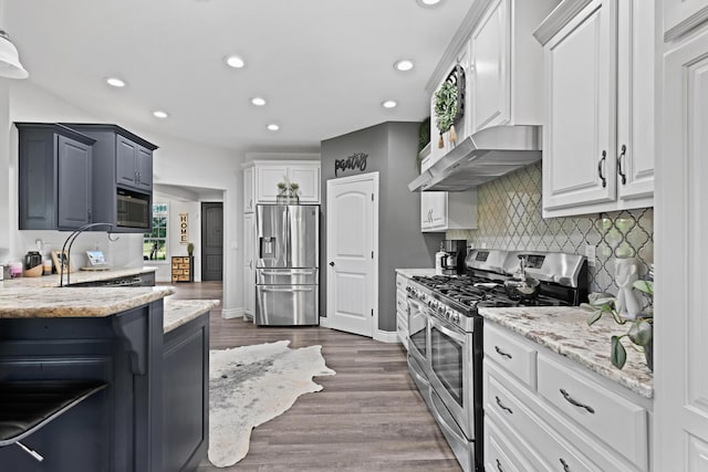 13030 County Lane 228, Oronogo, MO 64855 - kitchen with stainless steel appliances, recessed lighting, decorative backsplash, light stone countertops, and exhaust hood