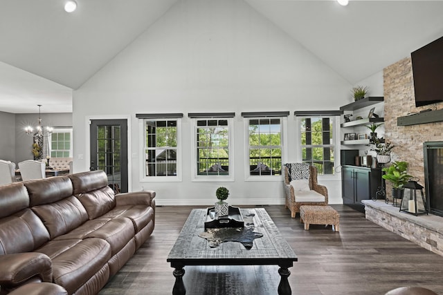 13030 County Lane 228, Oronogo, MO 64855 - living room featuring high vaulted ceiling, a chandelier, a stone fireplace, dark wood finished floors, and healthy amount of natural light