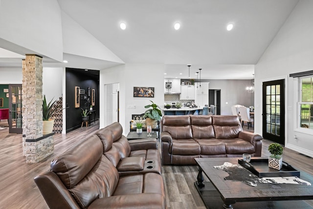 13030 County Lane 228, Oronogo, MO 64855 - living area featuring ornate columns, high vaulted ceiling, wood finished floors, a chandelier, and recessed lighting