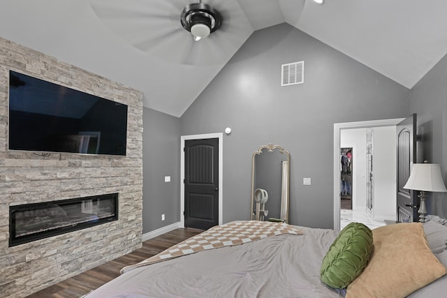 13030 County Lane 228, Oronogo, MO 64855 - bedroom with a spacious closet, high vaulted ceiling, wood finished floors, a fireplace, and ceiling fan