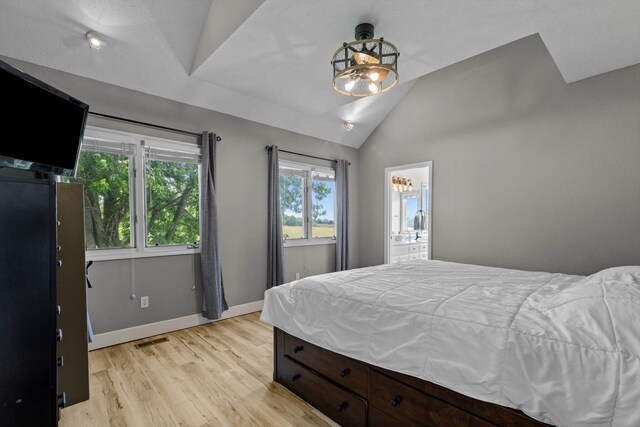 4201 N Farm Rd Unit 205, Strafford, MO 65757 - bedroom with vaulted ceiling, light wood-style flooring, and ensuite bathroom
