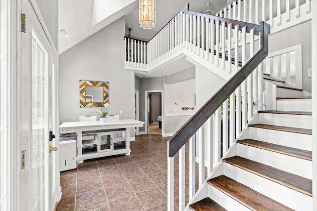 4201 N Farm Rd Unit 205, Strafford, MO 65757 - staircase featuring high vaulted ceiling and tile patterned flooring