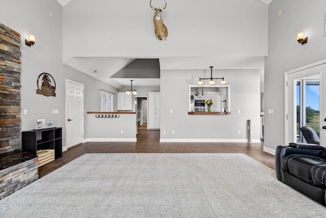 4201 N Farm Rd Unit 205, Strafford, MO 65757 - living area with high vaulted ceiling, dark tile patterned flooring, and plenty of natural light