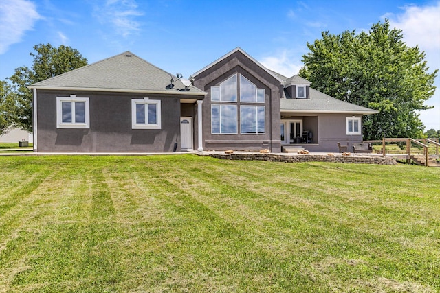 4201 N Farm Rd Unit 205, Strafford, MO 65757 - rear view of property featuring a lawn, stucco siding, a patio, and roof with shingles
