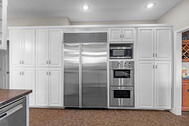 4201 N Farm Rd Unit 205, Strafford, MO 65757 - kitchen featuring appliances with stainless steel finishes, dark countertops, white cabinets, and recessed lighting