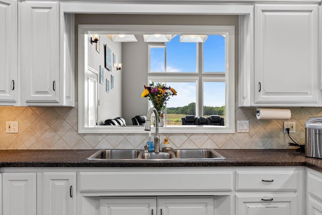 4201 N Farm Rd Unit 205, Strafford, MO 65757 - kitchen with dark countertops, white cabinets, and backsplash