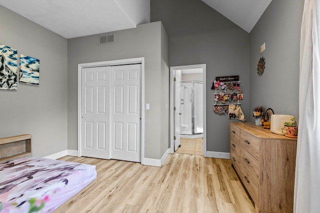 4201 N Farm Rd Unit 205, Strafford, MO 65757 - bedroom with light wood-style flooring, a closet, lofted ceiling, and ensuite bathroom