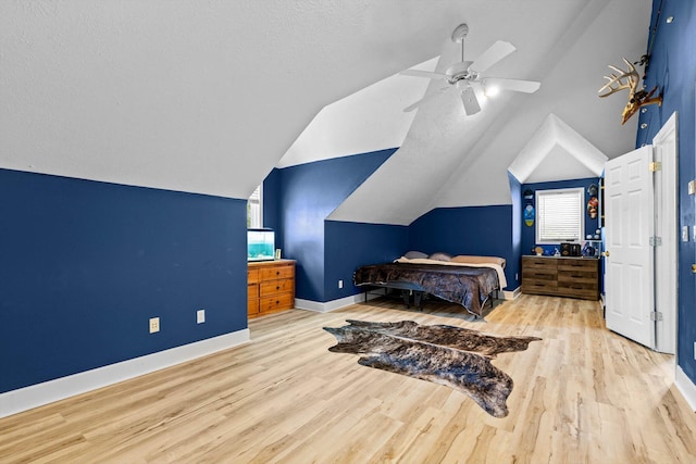 4201 N Farm Rd Unit 205, Strafford, MO 65757 - bedroom featuring vaulted ceiling, multiple windows, wood finished floors, ceiling fan, and a textured ceiling