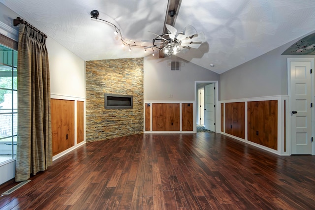 5795 S Wedgewood Ave, Springfield, MO 65810 - unfurnished living room featuring vaulted ceiling, a ceiling fan, wood-type flooring, a stone fireplace, and track lighting
