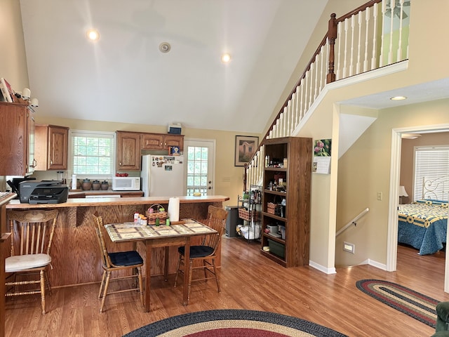26569 County Road 225, Flemington, MO 65650 - dining room with healthy amount of natural light, wood finished floors, high vaulted ceiling, and recessed lighting