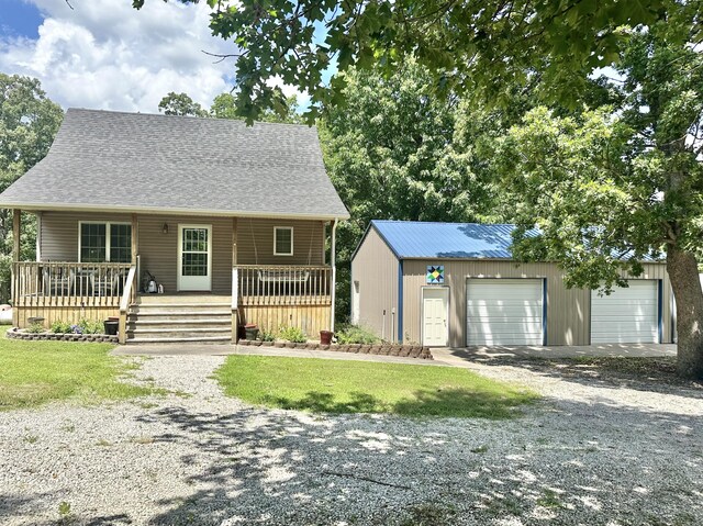 26569 County Road 225, Flemington, MO 65650 - view of front of house featuring an outbuilding, a garage, and a front yard