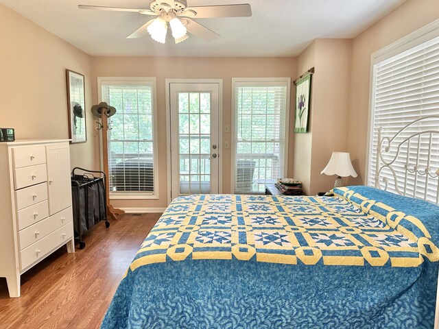 26569 County Road 225, Flemington, MO 65650 - bedroom featuring wood finished floors, multiple windows, access to exterior, and a ceiling fan