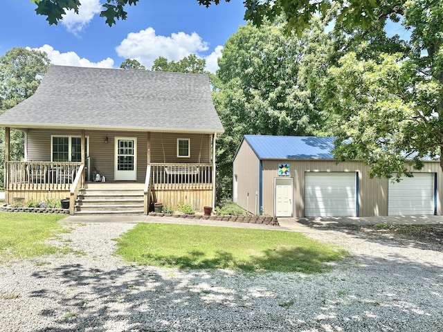 26569 County Road 225, Flemington, MO 65650 - view of front of home featuring a garage, an outbuilding, a front yard, roof with shingles, and covered porch