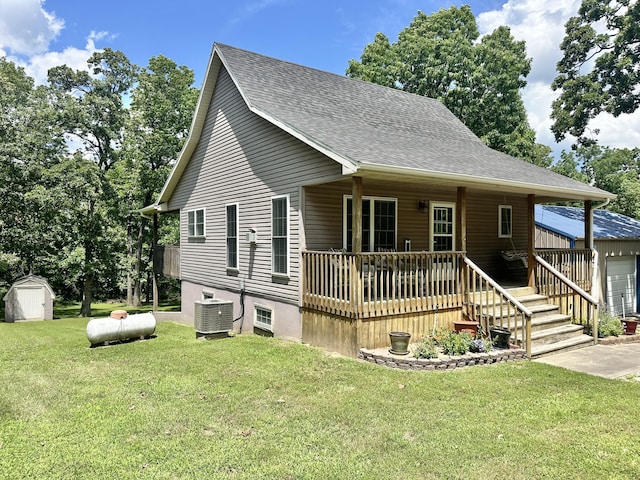 26569 County Road 225, Flemington, MO 65650 - view of front of property with a shed, a shingled roof, a front yard, and covered porch