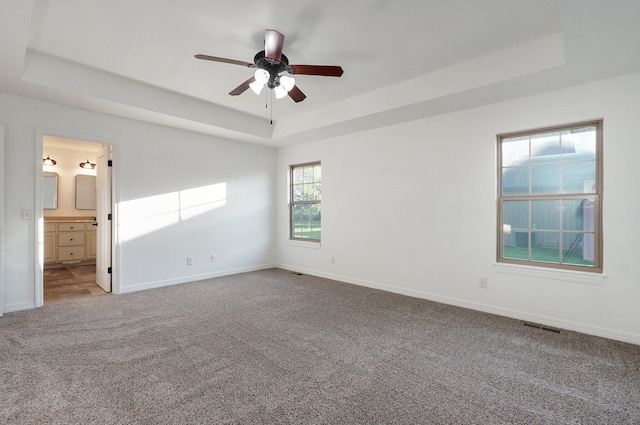 2000 E Greenwich Dr, Ozark, MO 65721 - empty room featuring a raised ceiling, carpet, and ceiling fan