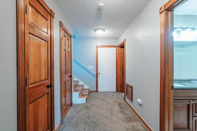 4147 E Kellis Ct, Springfield, MO 65802 - corridor featuring light carpet, a textured ceiling, and stairs