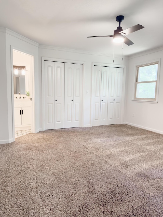 105 Horseshoe Dr, Nixa, MO 65714 - unfurnished bedroom featuring two closets, ornamental molding, carpet flooring, a ceiling fan, and ensuite bathroom