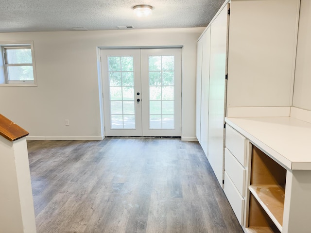 105 Horseshoe Dr, Nixa, MO 65714 - doorway featuring french doors, wood finished floors, and a textured ceiling
