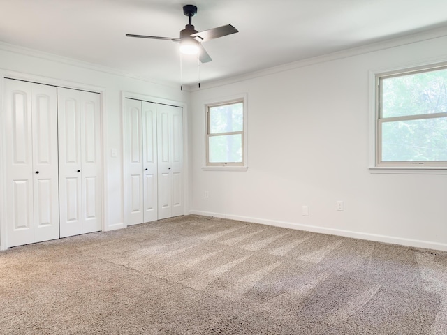 105 Horseshoe Dr, Nixa, MO 65714 - unfurnished bedroom with multiple closets, carpet, ornamental molding, and ceiling fan