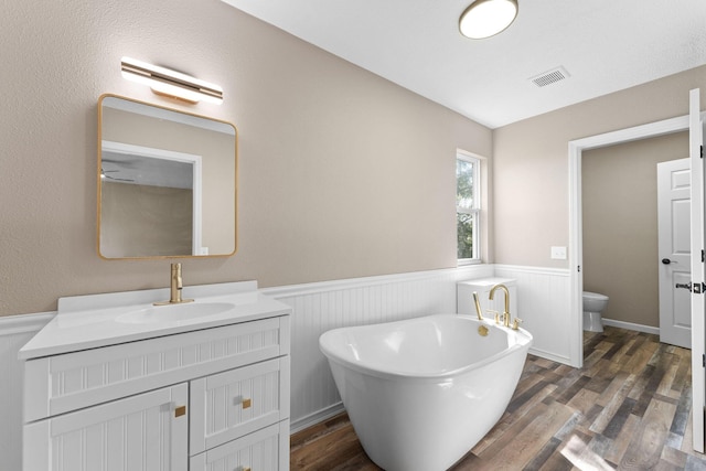 2505 Talking Rocks Rd, Branson West, MO 65737 - full bath featuring a wainscoted wall, a soaking tub, vanity, and wood finished floors