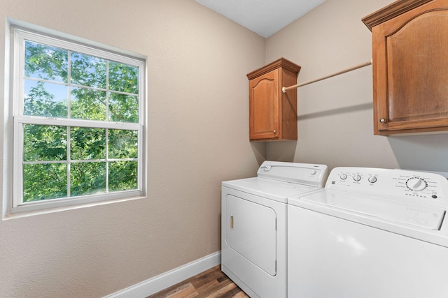 2505 Talking Rocks Rd, Branson West, MO 65737 - washroom with cabinet space, washing machine and clothes dryer, and wood finished floors