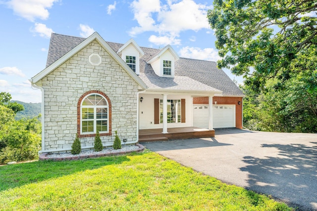 2505 Talking Rocks Rd, Branson West, MO 65737 - view of front of home with stone siding, covered porch, driveway, a garage, and roof with shingles