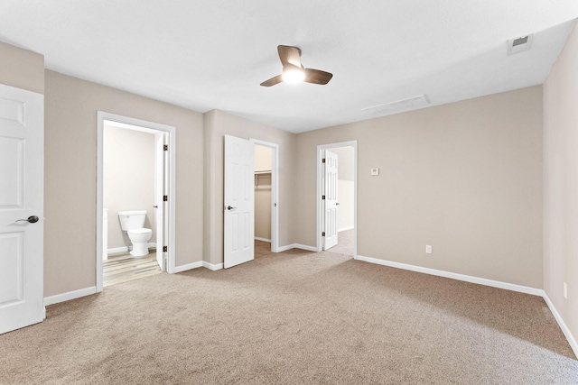 2505 Talking Rocks Rd, Branson West, MO 65737 - unfurnished bedroom with carpet floors, a walk in closet, ensuite bath, and a ceiling fan