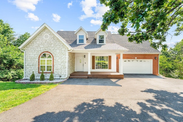 2505 Talking Rocks Rd, Branson West, MO 65737 - view of front of home featuring driveway, stone siding, a porch, a garage, and a shingled roof