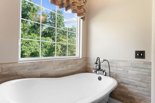 2505 Talking Rocks Rd, Branson West, MO 65737 - bathroom with a soaking tub, tile walls, and a textured wall