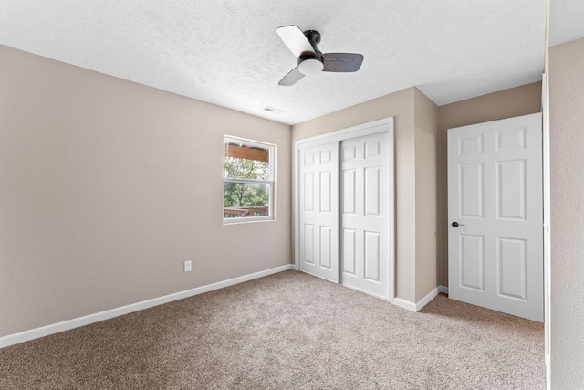 2505 Talking Rocks Rd, Branson West, MO 65737 - unfurnished bedroom featuring a closet, carpet floors, ceiling fan, and a textured ceiling