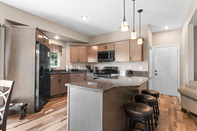 2505 Talking Rocks Rd, Branson West, MO 65737 - kitchen featuring electric range oven, black refrigerator with ice dispenser, light wood finished floors, a peninsula, and a textured ceiling