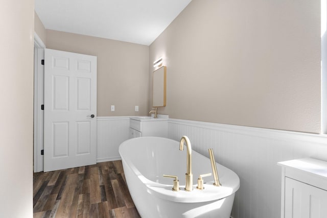 2505 Talking Rocks Rd, Branson West, MO 65737 - full bath featuring a freestanding bath, a wainscoted wall, vanity, and wood finished floors