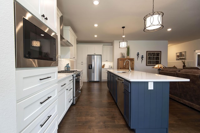 1604 N Bristol Ave, Springfield, MO 65802 - kitchen with appliances with stainless steel finishes, dark wood finished floors, light countertops, white cabinets, and recessed lighting