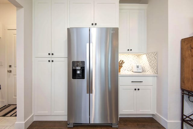 1604 N Bristol Ave, Springfield, MO 65802 - kitchen featuring stainless steel refrigerator with ice dispenser, backsplash, white cabinetry, dark wood-style floors, and light countertops