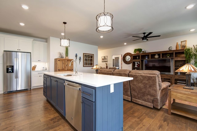 1604 N Bristol Ave, Springfield, MO 65802 - kitchen featuring stainless steel appliances, blue cabinets, white cabinets, light countertops, and recessed lighting