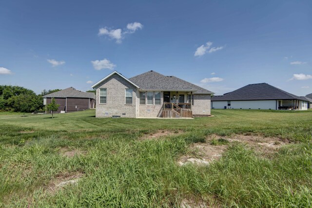 1604 N Bristol Ave, Springfield, MO 65802 - rear view of house featuring brick siding and a lawn