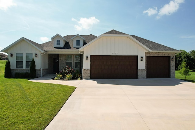 1604 N Bristol Ave, Springfield, MO 65802 - view of front facade with an attached garage, brick siding, concrete driveway, board and batten siding, and a front lawn