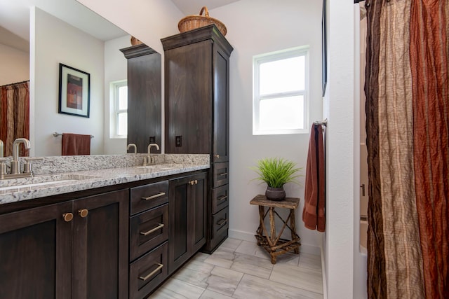 1604 N Bristol Ave, Springfield, MO 65802 - bathroom with double vanity, marble finish floors, and shower / tub combo