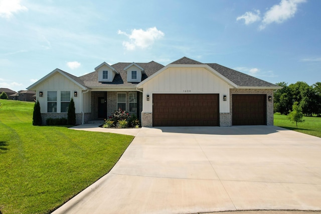 1604 N Bristol Ave, Springfield, MO 65802 - view of front of home with a garage, brick siding, board and batten siding, and a front yard