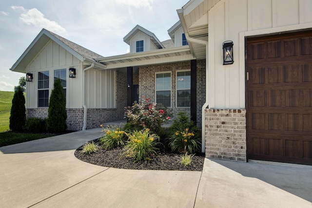 1604 N Bristol Ave, Springfield, MO 65802 - doorway to property featuring board and batten siding, brick siding, and a porch