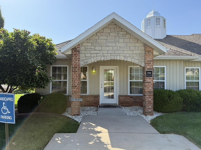 1352 N Sandy Creek Cir Unit 3, Nixa, MO 65714 - doorway to property featuring roof with shingles, board and batten siding, a chimney, and stone siding