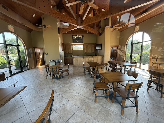 1352 N Sandy Creek Cir Unit 3, Nixa, MO 65714 - dining space with a towering ceiling, a ceiling fan, healthy amount of natural light, beam ceiling, and light tile patterned floors