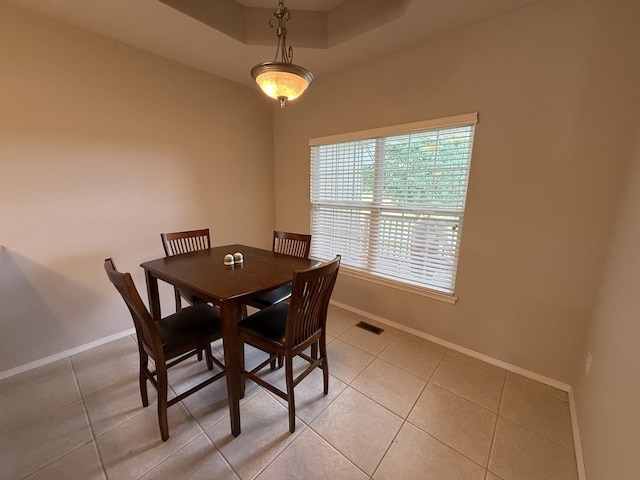 1352 N Sandy Creek Cir Unit 3, Nixa, MO 65714 - dining area featuring light tile patterned floors and a tray ceiling