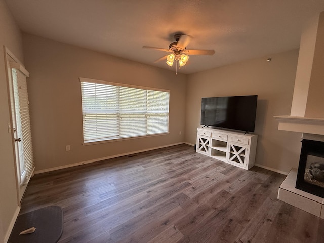 1352 N Sandy Creek Cir Unit 3, Nixa, MO 65714 - unfurnished living room with a ceiling fan, wood finished floors, and a fireplace