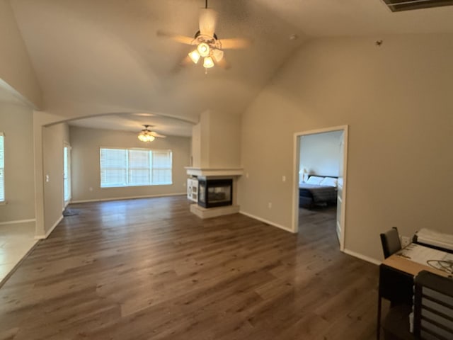 1352 N Sandy Creek Cir Unit 3, Nixa, MO 65714 - unfurnished living room with ceiling fan, wood finished floors, a multi sided fireplace, high vaulted ceiling, and arched walkways