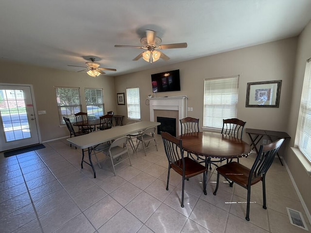 1352 N Sandy Creek Cir Unit 3, Nixa, MO 65714 - dining area featuring plenty of natural light, a fireplace, light tile patterned flooring, and ceiling fan
