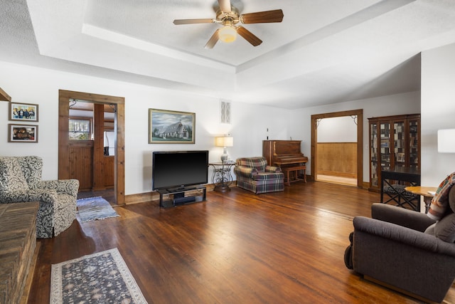 400 E Walker St, Ash Grove, MO 65604 - living room with wood finished floors, a ceiling fan, and a raised ceiling
