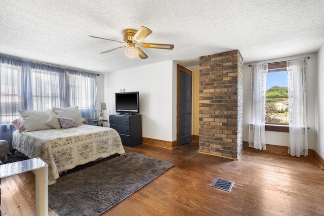 400 E Walker St, Ash Grove, MO 65604 - bedroom with multiple windows, wood-type flooring, a textured ceiling, and ceiling fan