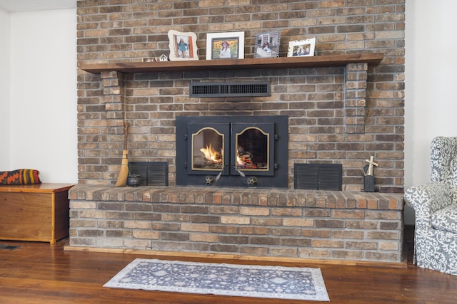400 E Walker St, Ash Grove, MO 65604 - detailed view of wood finished floors and a brick fireplace