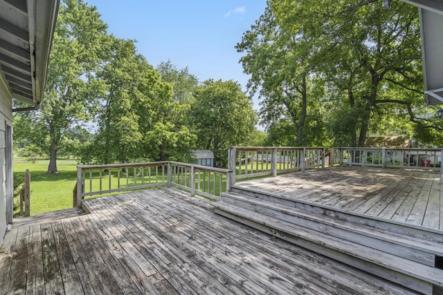 400 E Walker St, Ash Grove, MO 65604 - deck featuring a storage unit, a yard, and view of wooded area